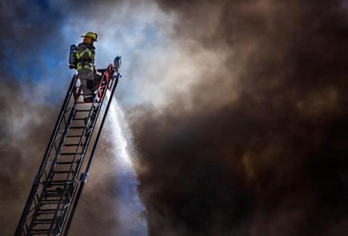 Firefighters spray water on a structure fire at B & L Meats in Buhl, Idaho. 